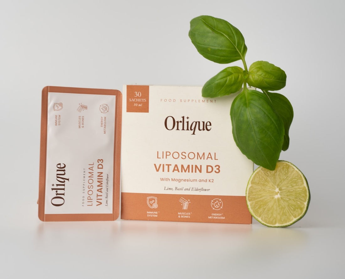 Packaging of Orlique Liposomal Vitamin D3 supplement with a leafy garnish and a slice of lime.